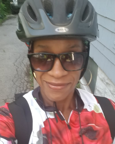 Vestina wearing a bicycle helmet and sunglasses.